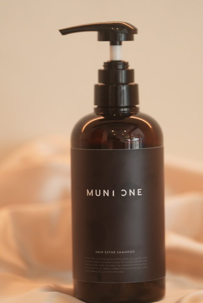 ムニワンシャンプー（MUNIONE HAIR ESTHE SHAMPOO）のボトル写真。サロンの髪質改善効果を持続させるためのヘマチン配合シャンプー。